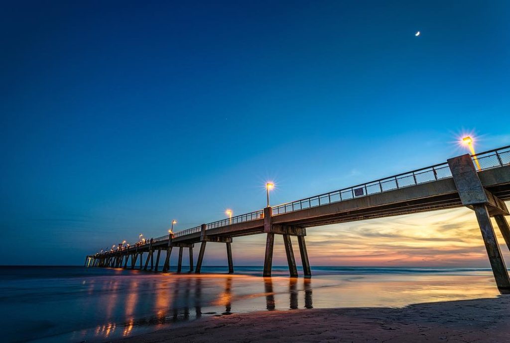 view of the beach and boardwalk during sunset with a clear sky as Fort Pickens Fishing Pier