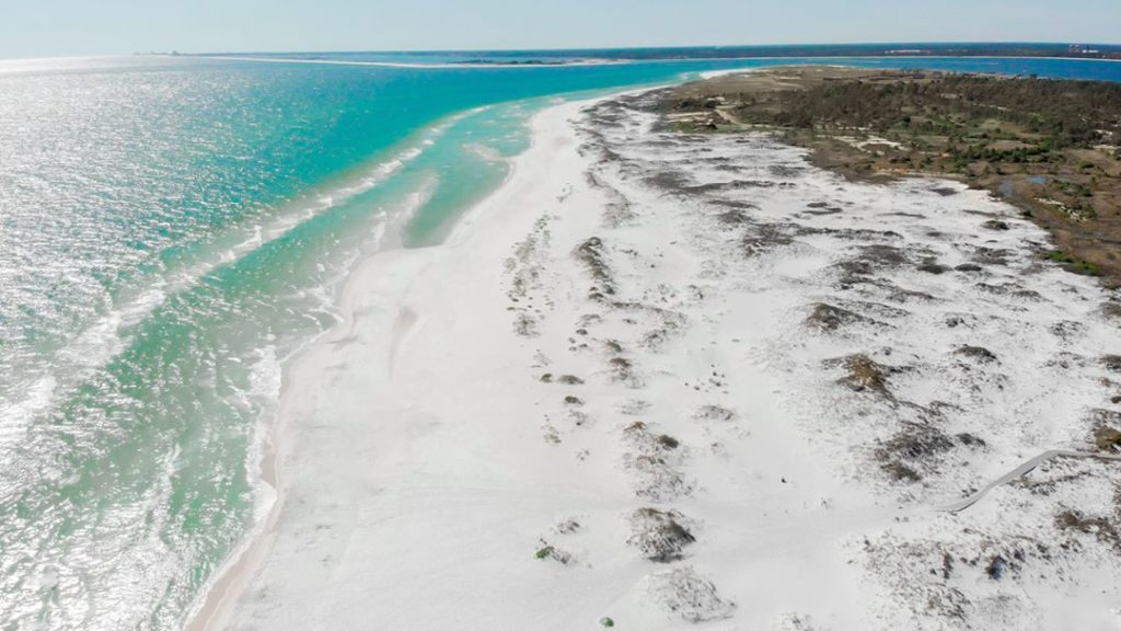 a white sand beach with beautiful bright blue waters at Gulf Islands National Seashore