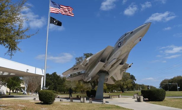 a military aircraft statue in front of he National Naval Aviation Museum