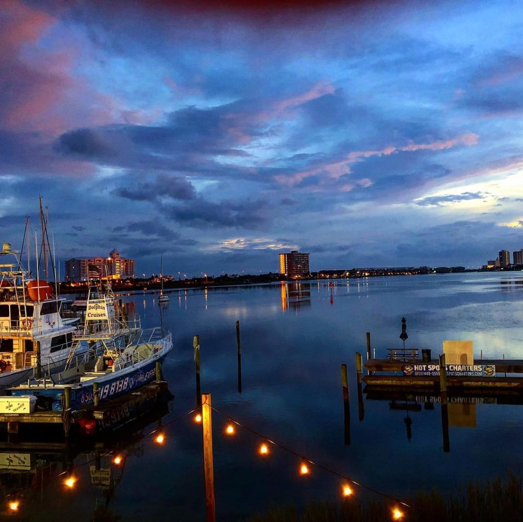 a view of the water and boats during the sunset 