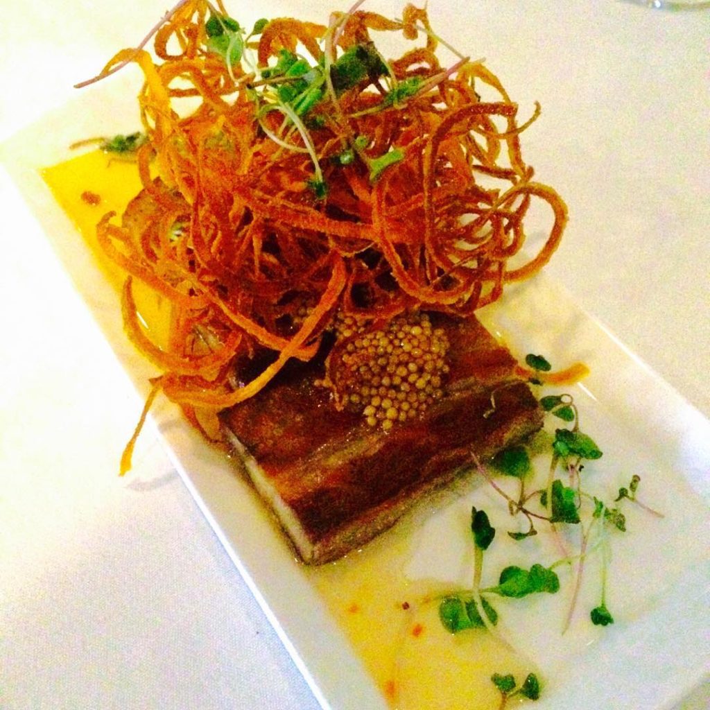 whiskey cured pork belly, with pickled mustard seeds, pepper jelly and and crispy sweet potato string on top