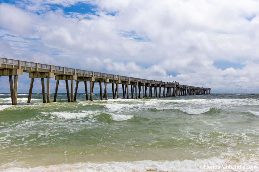 view of a pier from the water with waves