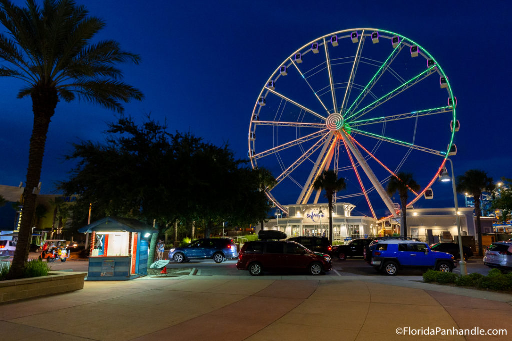 view of a colorful lit up ferris wheel in pier park florida