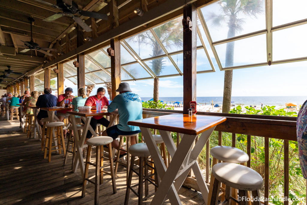 an open air window setting in front of a beach at a restaurant in florida
