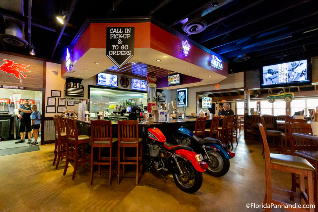 bar with two motorcycle chairs at The Wicked Wheel Bar and Grill