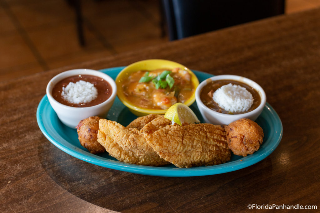 plate of fried fish, hush puppies and a side of rice and beans at Dee's Hang Out in Panama City Beach