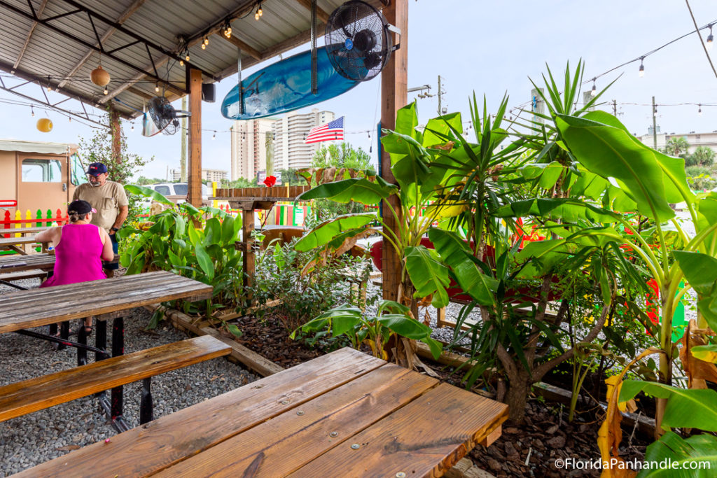 exterior patio area at finns island style grub cafe with tropical plants
