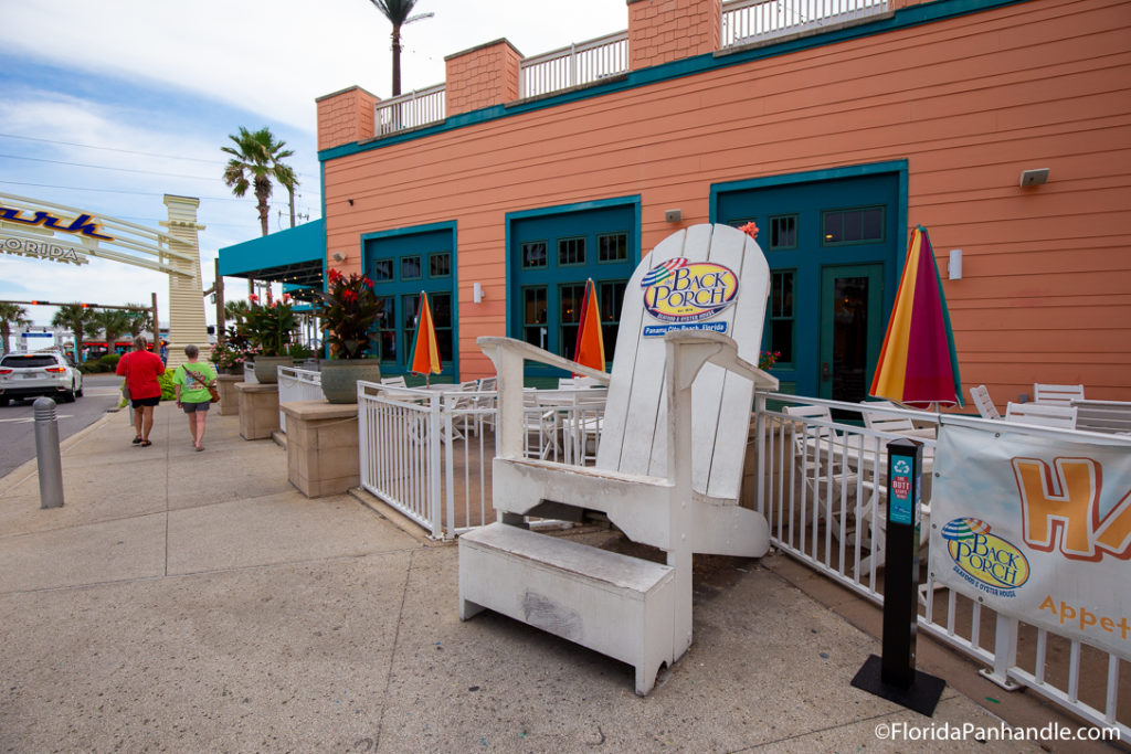 a big white beach chair on the side of a building 