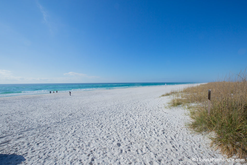 beautiful white sand beach with few people on a sunny day at Pensacola Dog Beach West