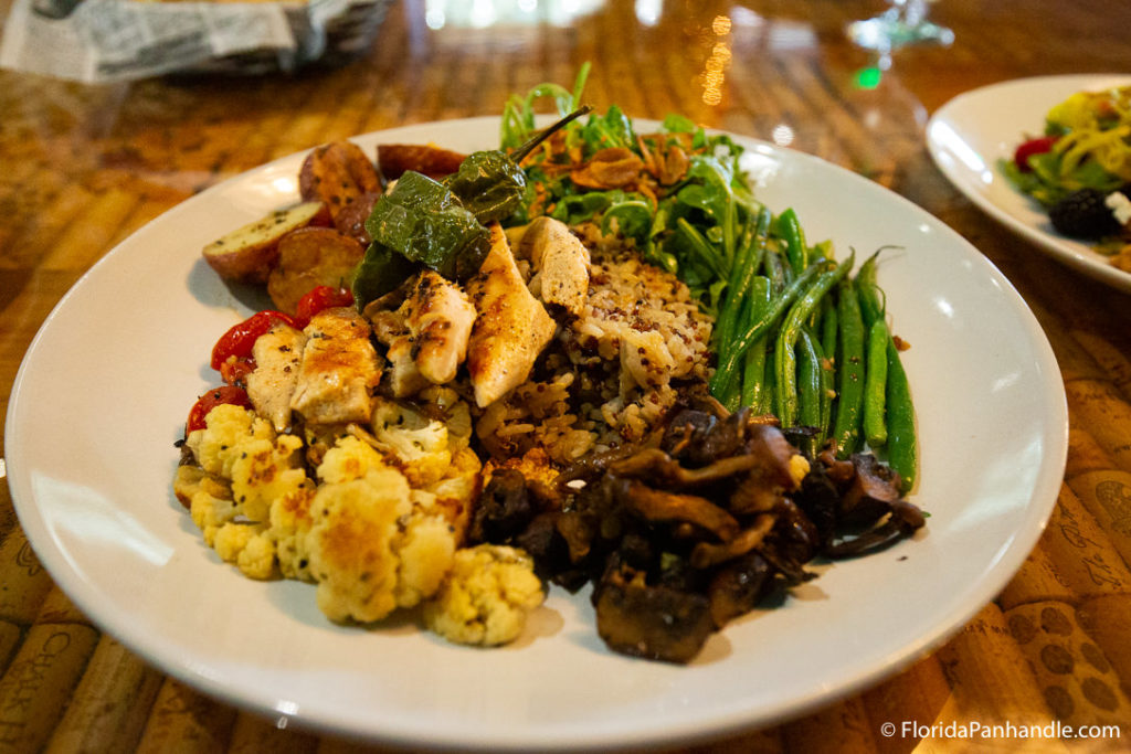 a plate of grilled chicken, stuffing, mushroom, potatoes and green beans