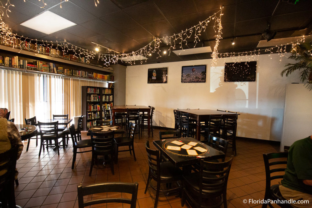 the inside dining are of a cozy coffee shop at Drowsy Poet Pensacola Beach