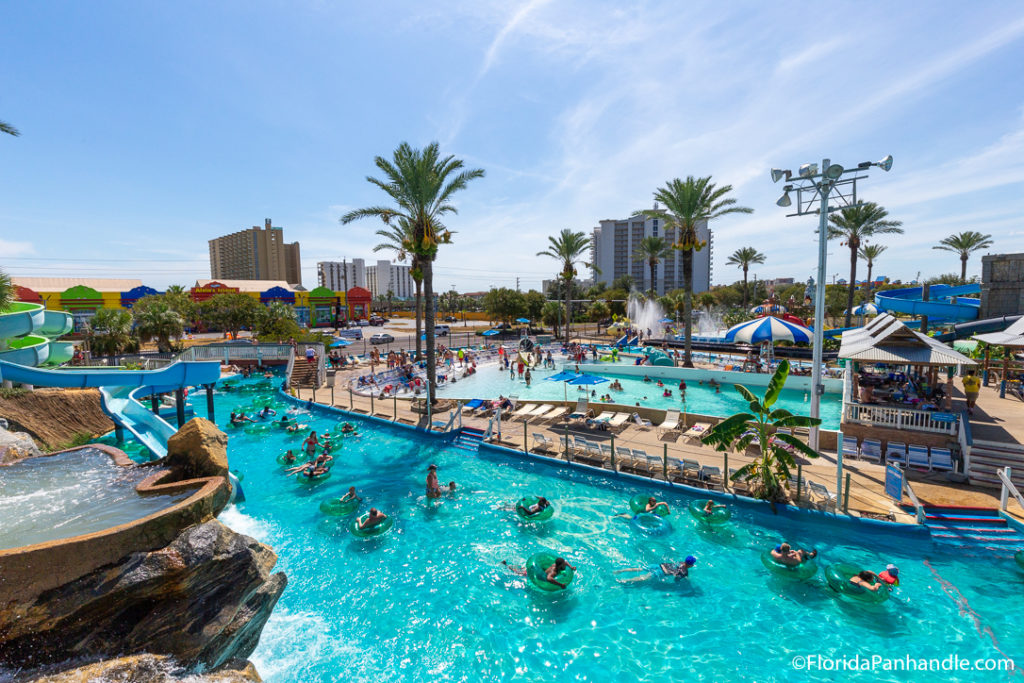 view of big kahunas water park in destin with people enjoying the water and palm trees