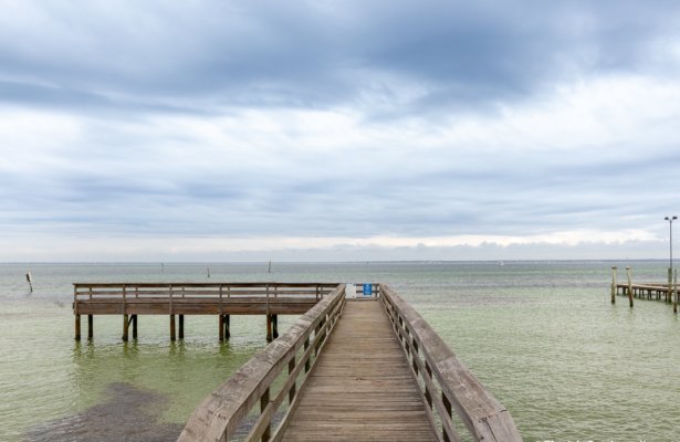 a pier in the water at Clement Taylor Park in Destin, Florida