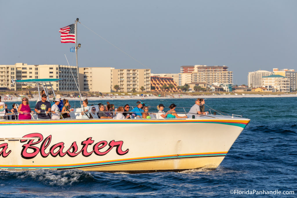 a group of people on a beat sailing through the water in Destin, Florida