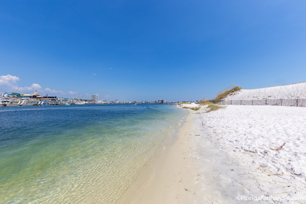 a white sanded beach with beautiful clear water with a clear blue sky at Norriego Point in Destin, Florida