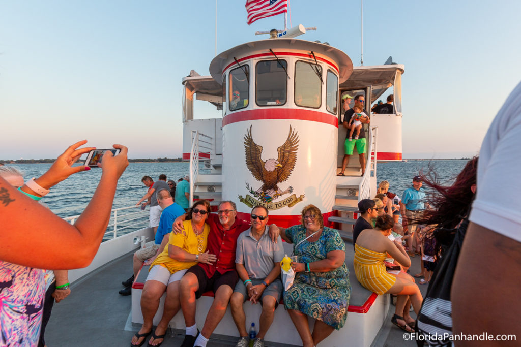 a group of people posing and smiling at the camera at the Southern Star Dolphin Cruise in Destin Florida