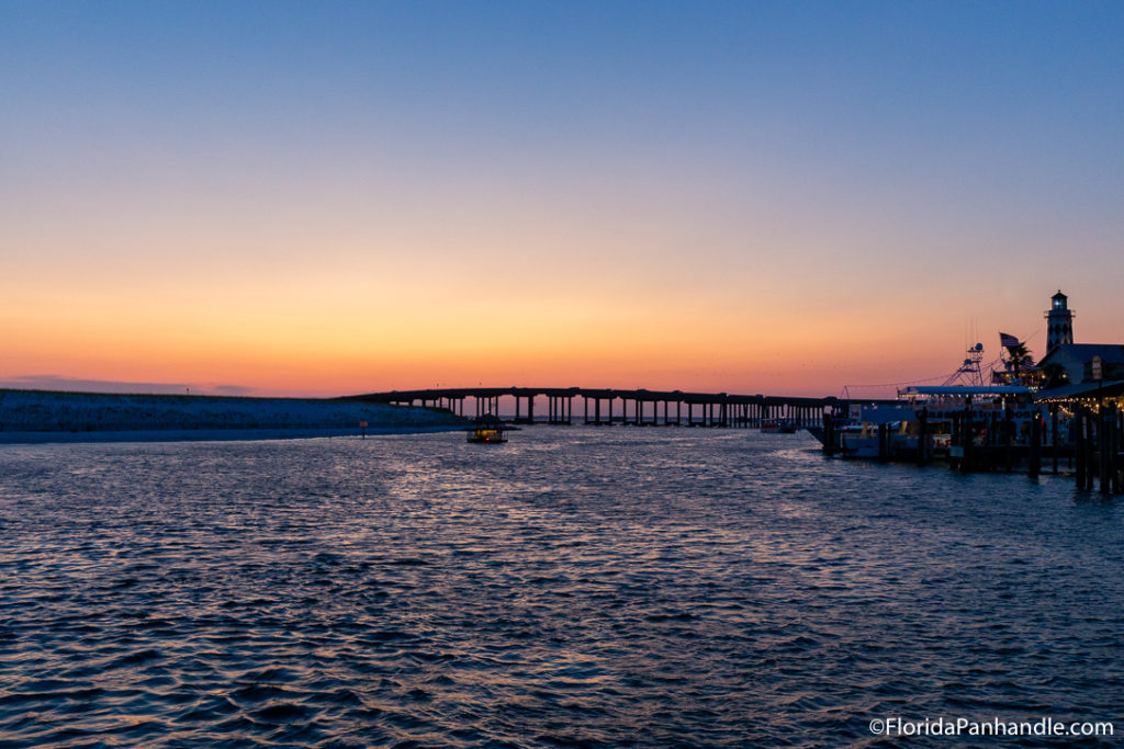 view of a bridge over the water, sunset, orange pink and blue skies, wintertimes, pcb