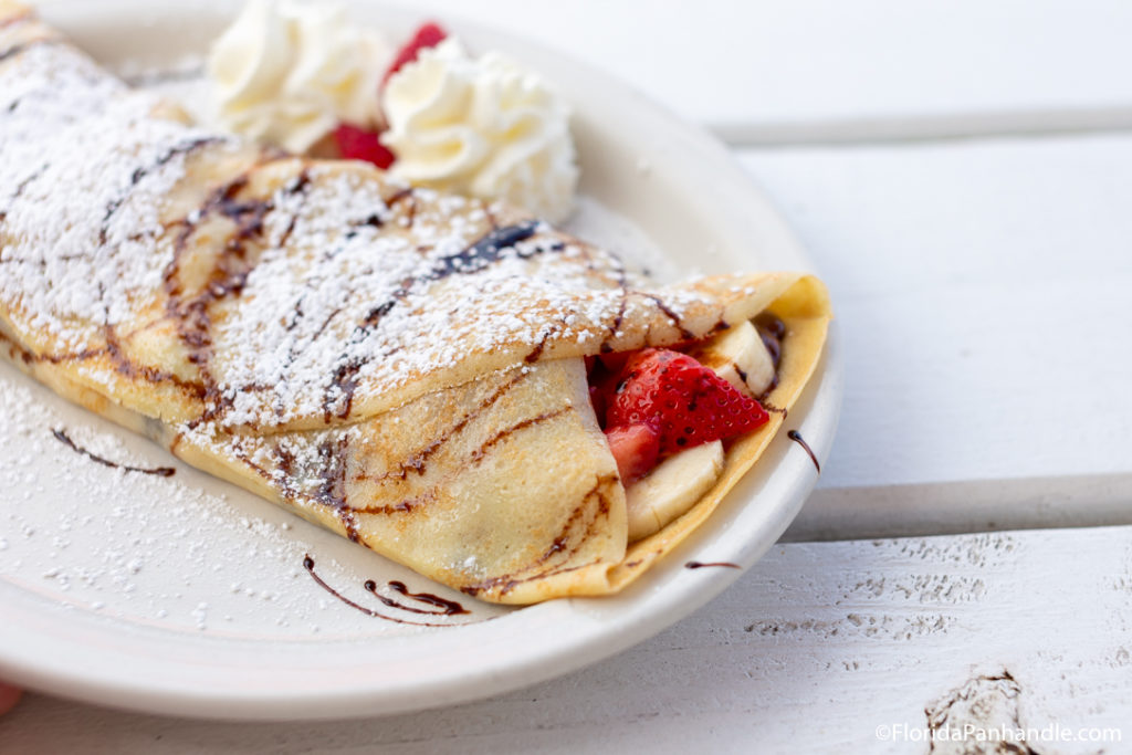 a crepe filled with bananas, strawberries and chocolate