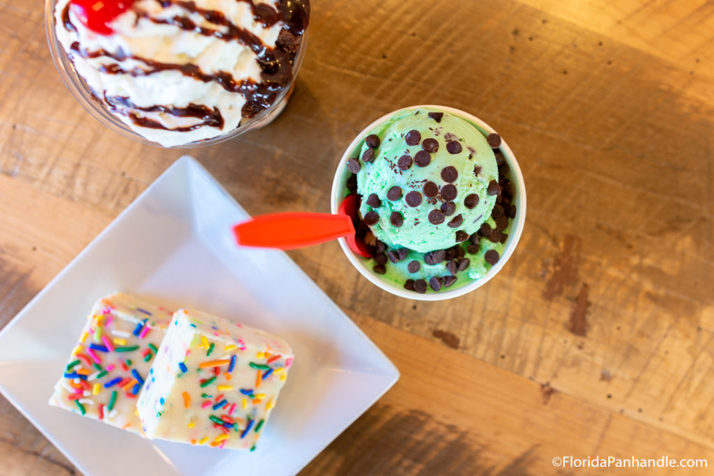 a cup of mint chocolate chip ice cream and confetti fudge with rainbow sprinkles on top at Miramar Beach Hangout 