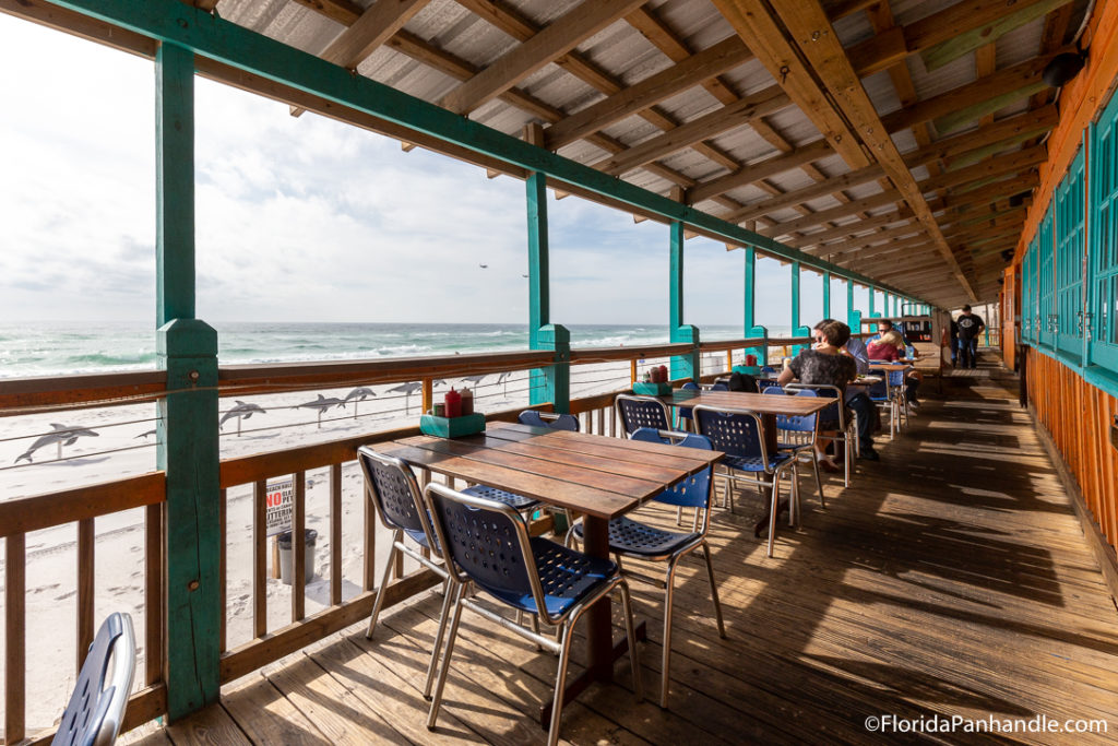 a covered outdoor dining area along the beach