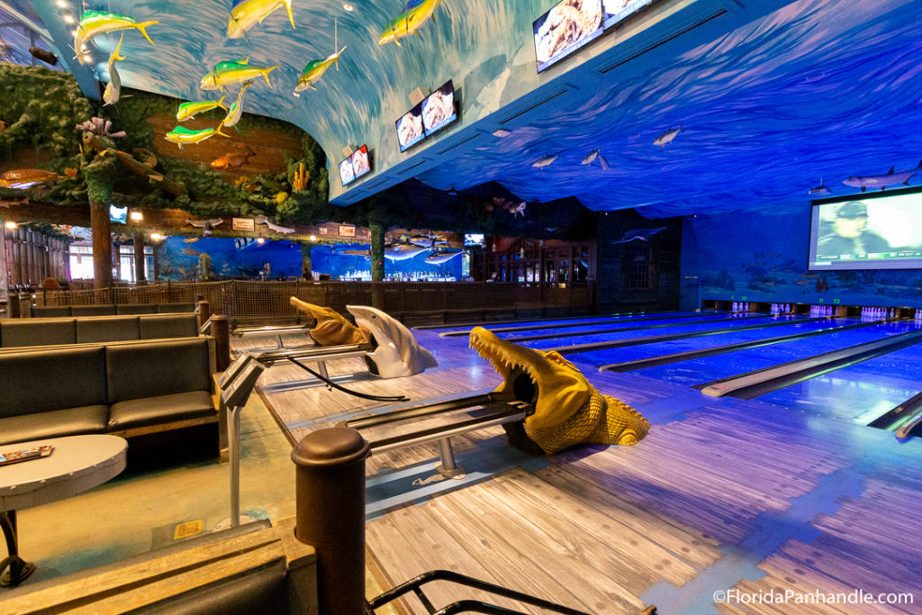 aquatic inspired bowling ally with fish decor hanging from this ceiling at Uncle Buck's Fishbowl & Grill