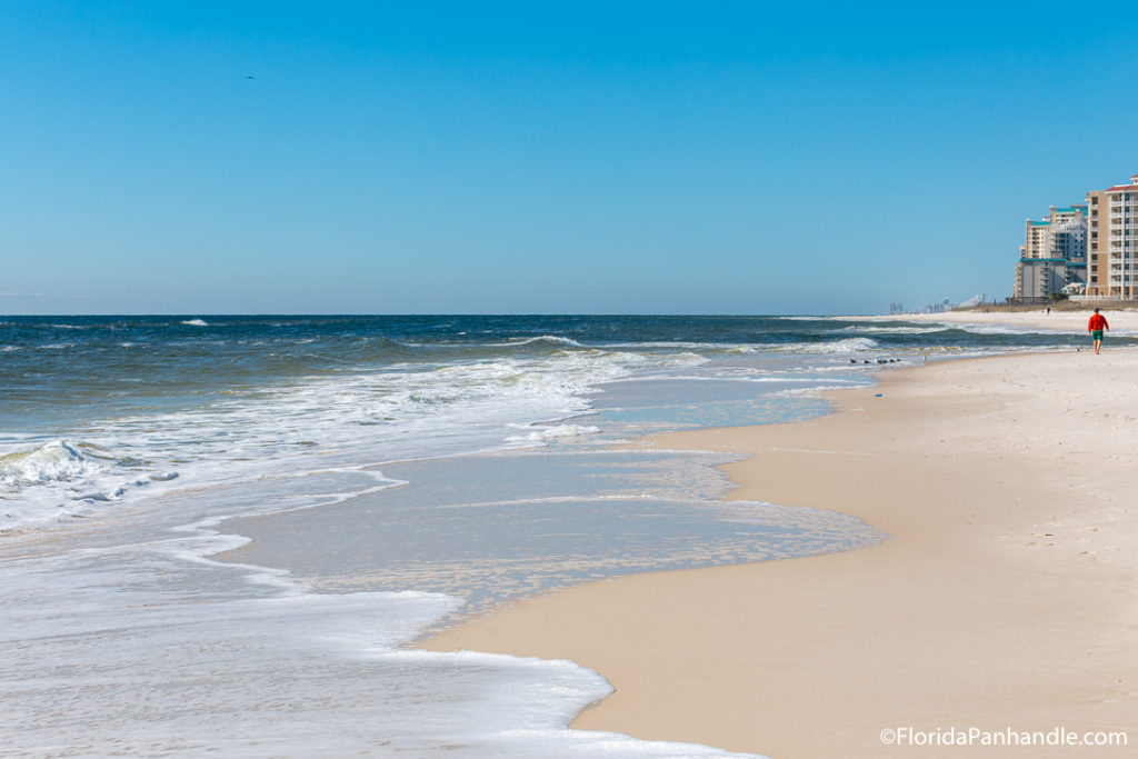 waves washing up on the shoreline on a sunny day with blue skies, destin beach