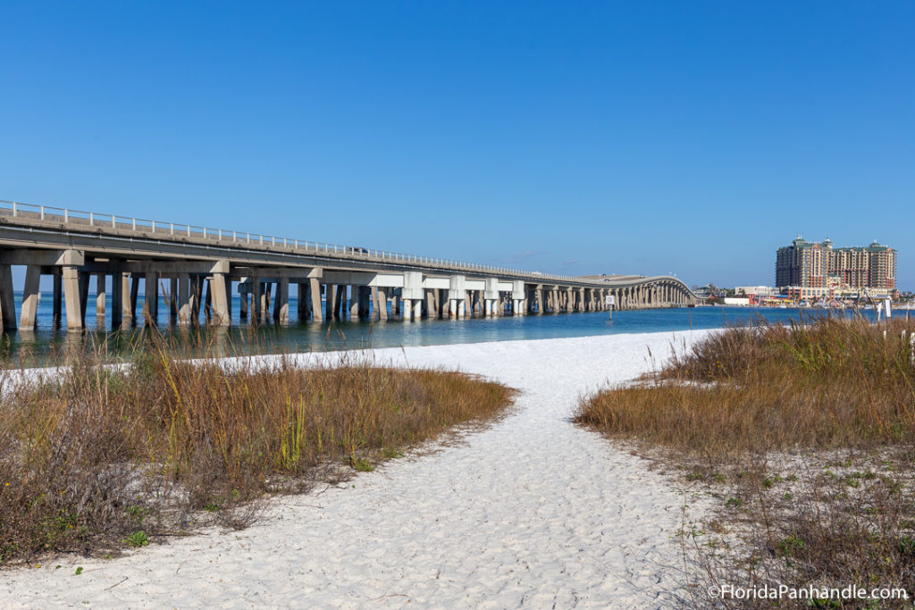 santa rosa beach with bridge on water in the background