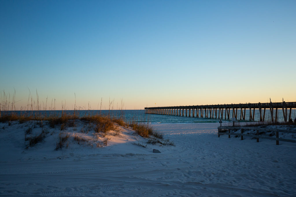 sunset going down with a pier next to casino beach in florida