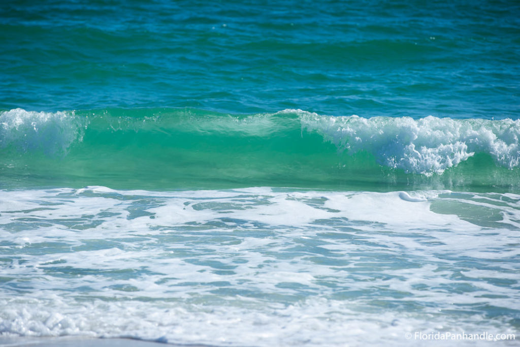 emerald green ocean waves rolling in