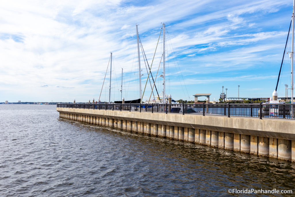 a boating pier with boats next to it at Pensacola Pier in Florida