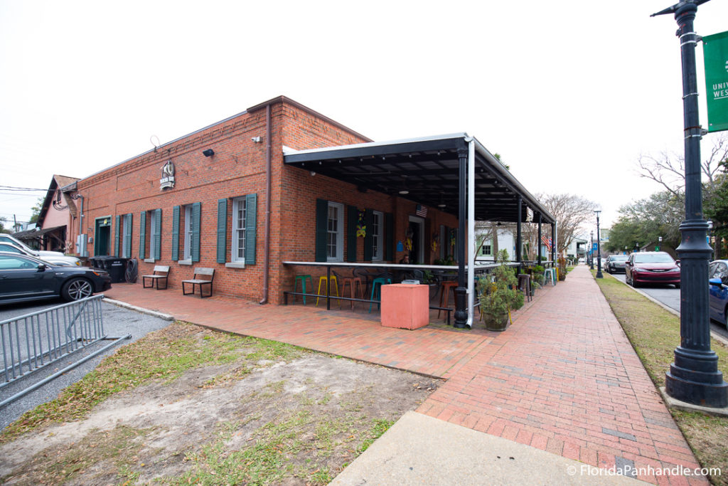 outside seating area and of restaurant at Pensacola Bay Brewery on a cloudy day