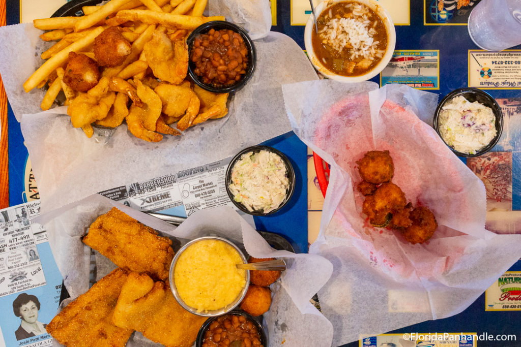 plates of fish and chips with sides of coleslaw at Captain Joey Patti's Seafood Restaurant and Deli