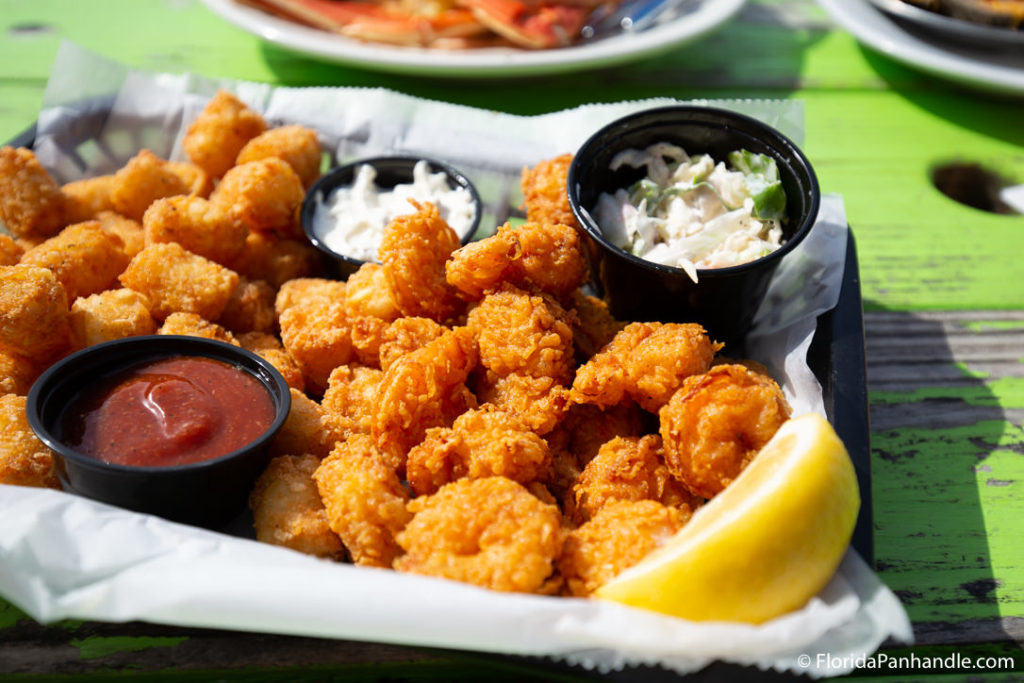 fried shrimp and tater tots in basket at pensacola seafood restaurant