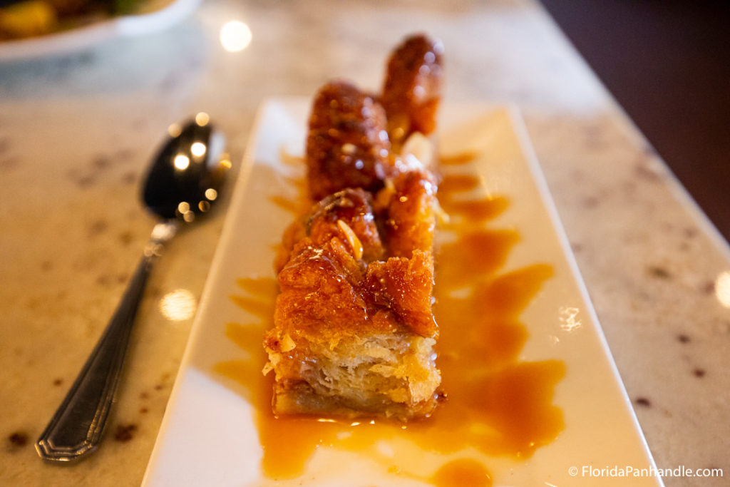 golden brown bread pudding on a white long plate