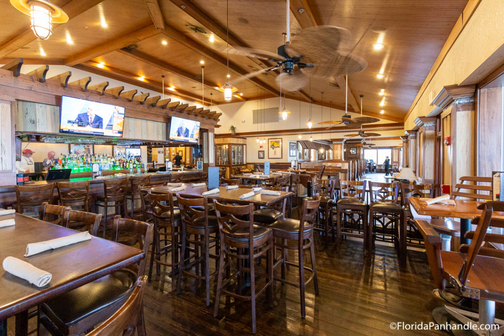 a dining area with hightop tables at Hemingway's Island Grill