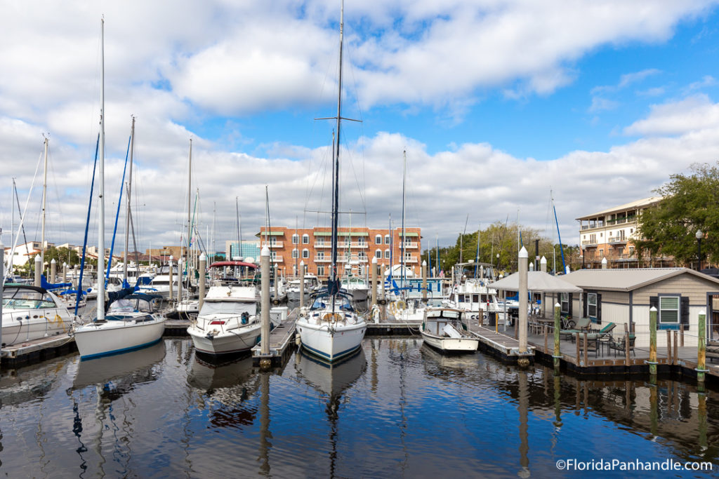 a boat dock with tons of boats on the water