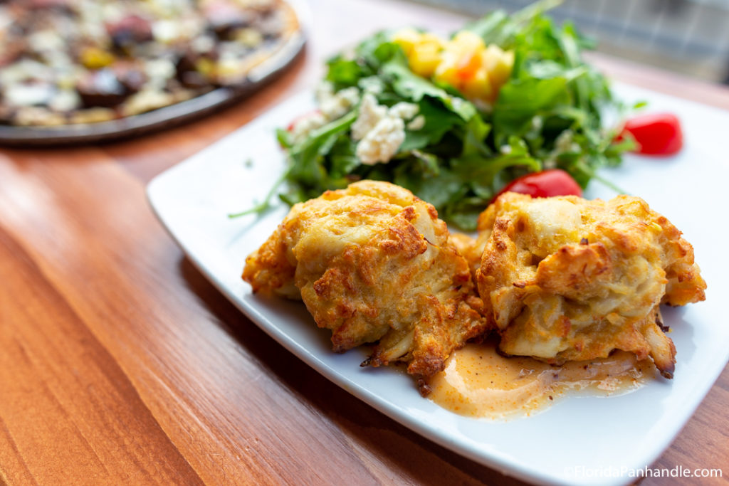 a plate of fried crab with a side of fresh salad at Jacob's Bayfront Bar and Grille