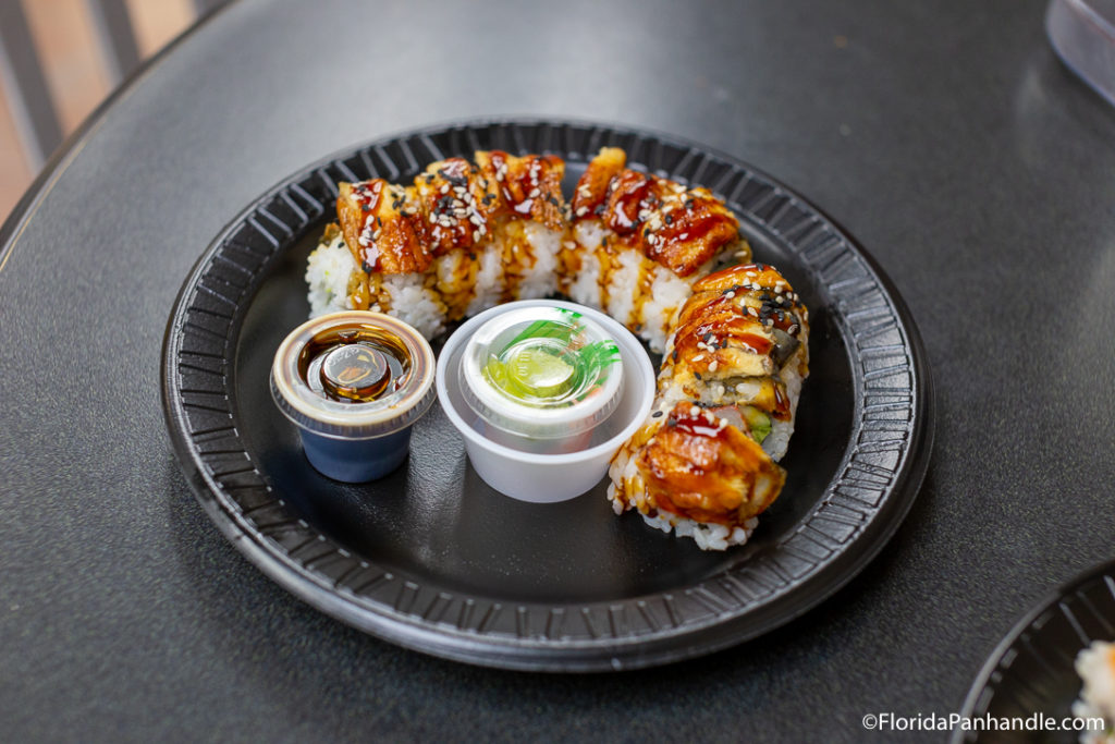 plate of a full sushi role with a side small container of soy sauce at Joe Patti's Seafood Market
