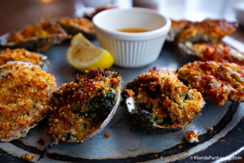 breaded fried clams with a side of melted butter dipping sauce and a lemon wedge at Peg Leg Petes in Pensacola Florida 