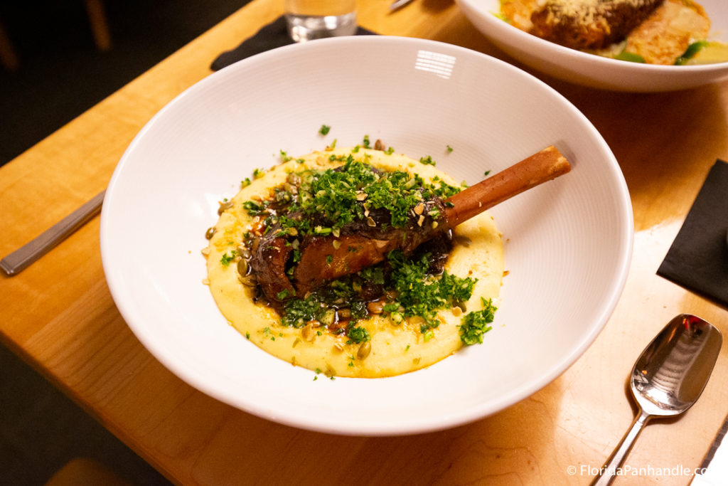 a lamb rack in a creamy potato puree with cilantro and herd on top at Restaurant IRON