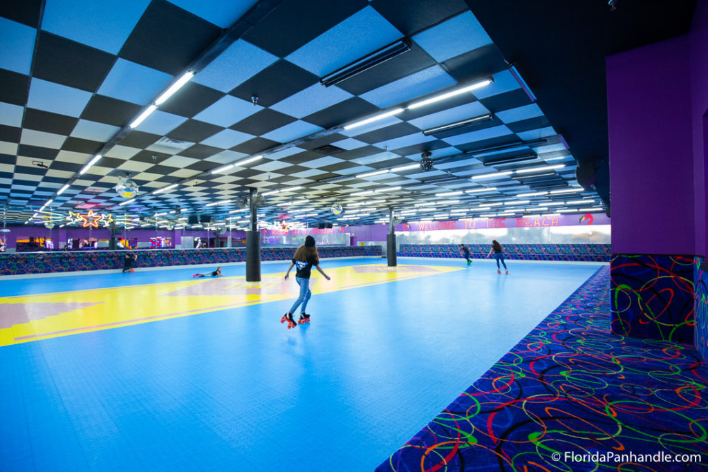 large roller skating rink with blue checkered ceiling at Rock'it Lanes