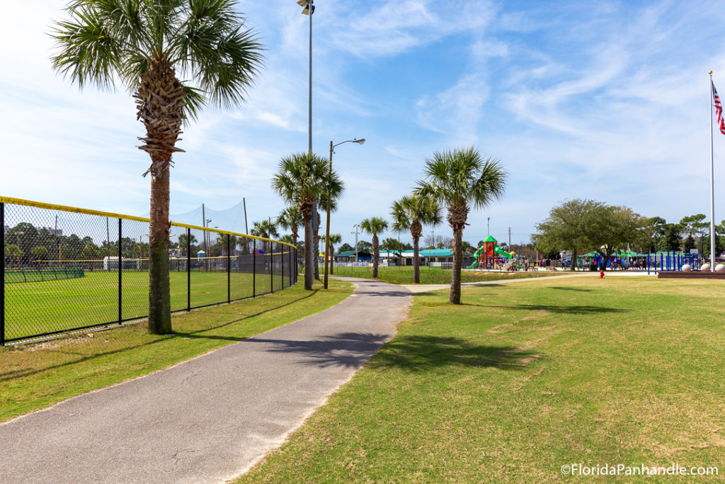 sidewalk next to a baseball field at Frank Brown Park in Panama City Beach