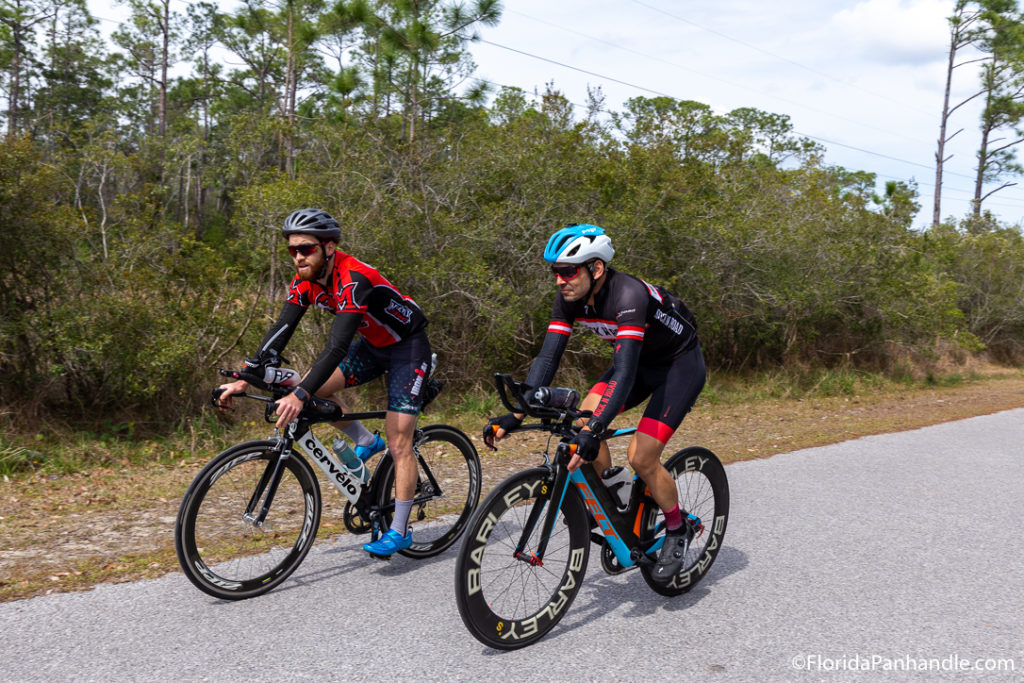 two men in tight clothes wearing helmets biking on Gayle's Trail  