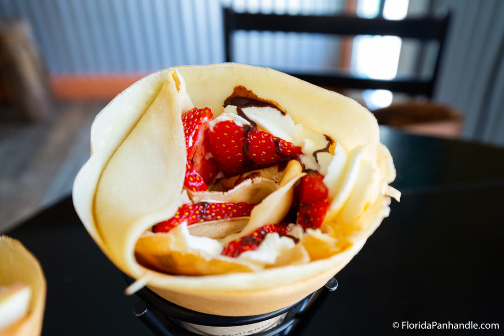 Crepe filled with strawberries, whip cream and chocolate drizzle at Gypsea Crepes in Panama City Florida