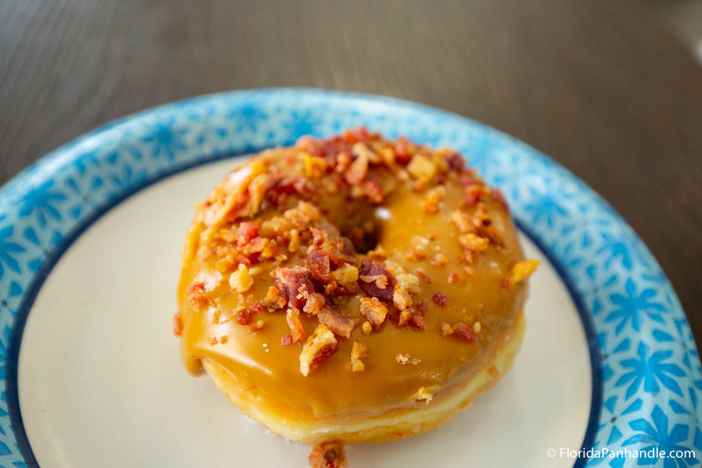 a perfect maple frosted donut with bacon bites sprinkled on top at Sunrise Cafe & Bakery