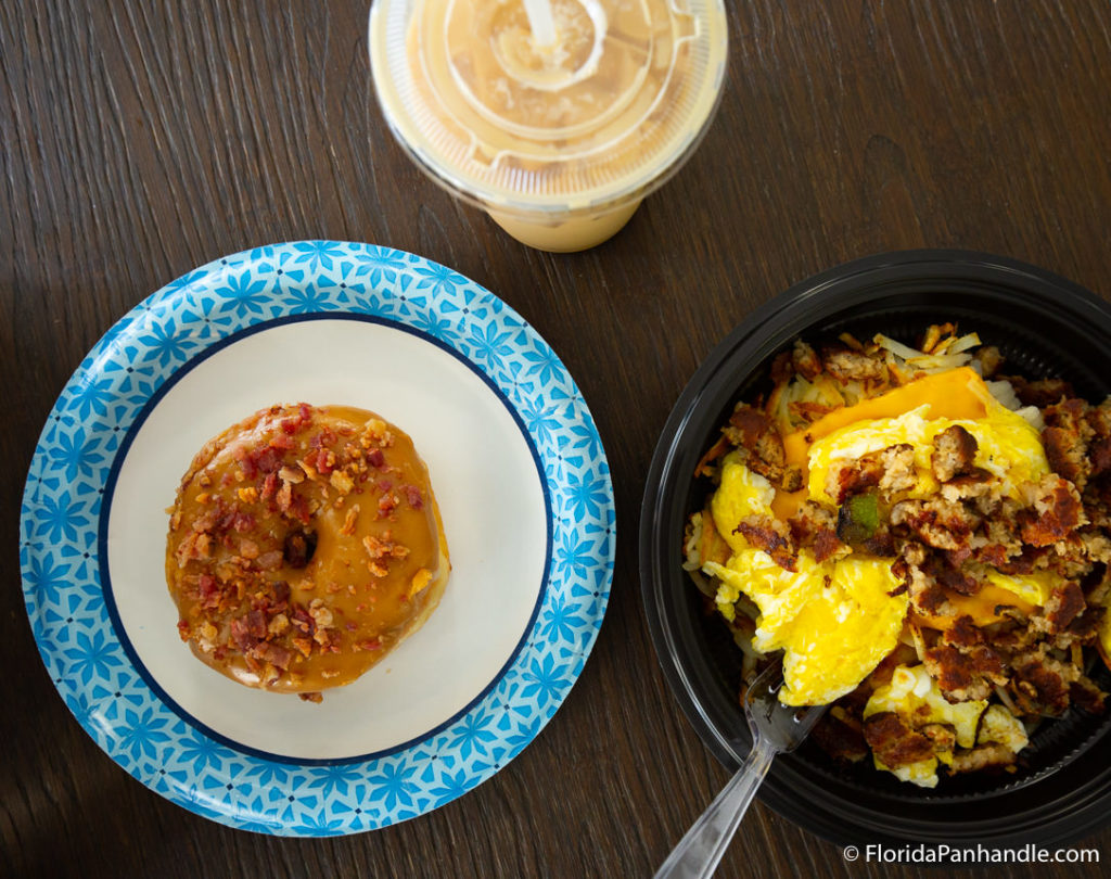 a breakfast bowl with a bacon maple frosted donut and iced coffee on the side at Sunrise Cafe & Bakery