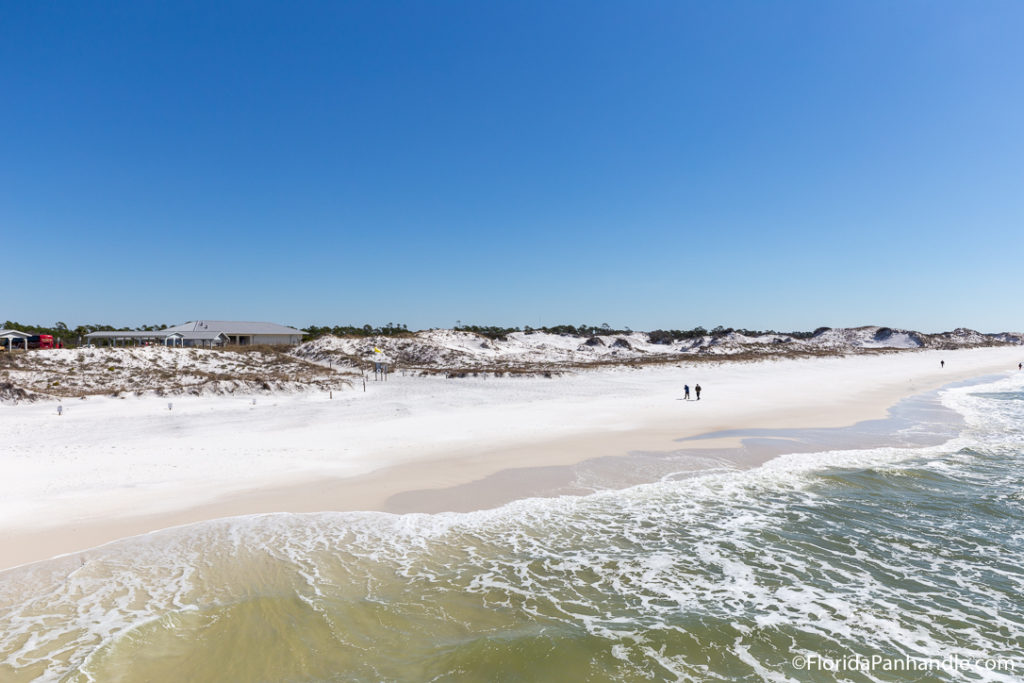 a view of an empty beach from the pier