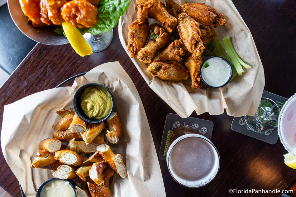 pretzel bites, dry rub bone in chicken wings and a glass of beer