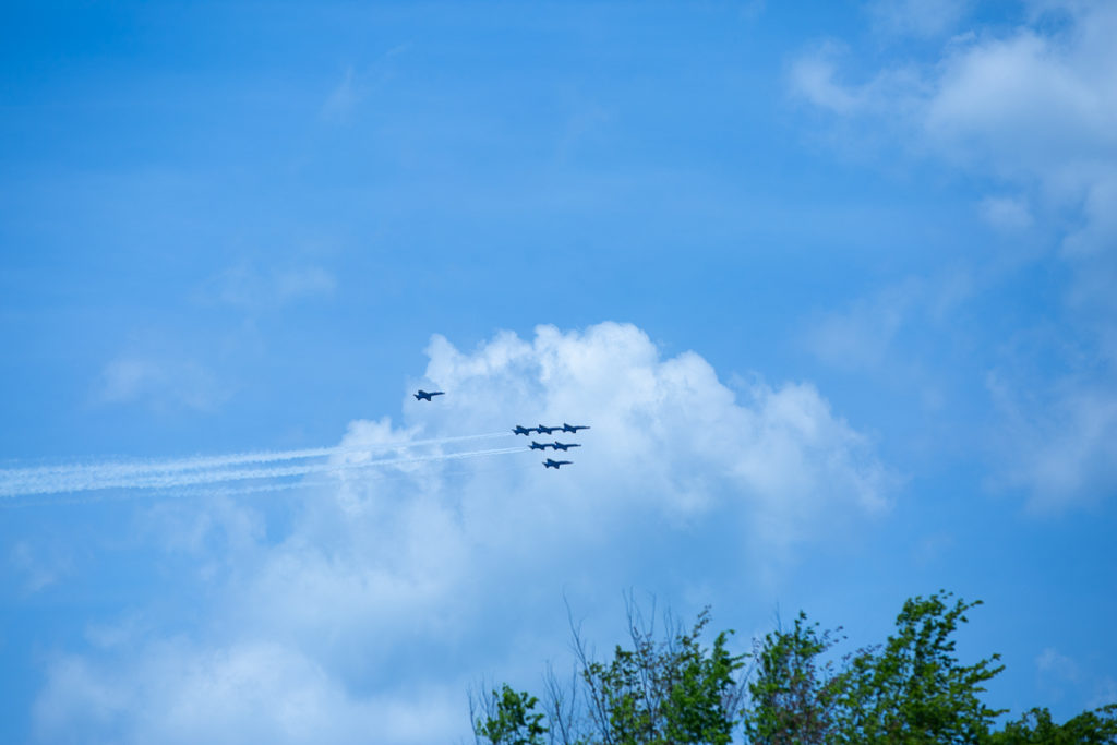 seven fighter jets flying in the sky on a sunny day