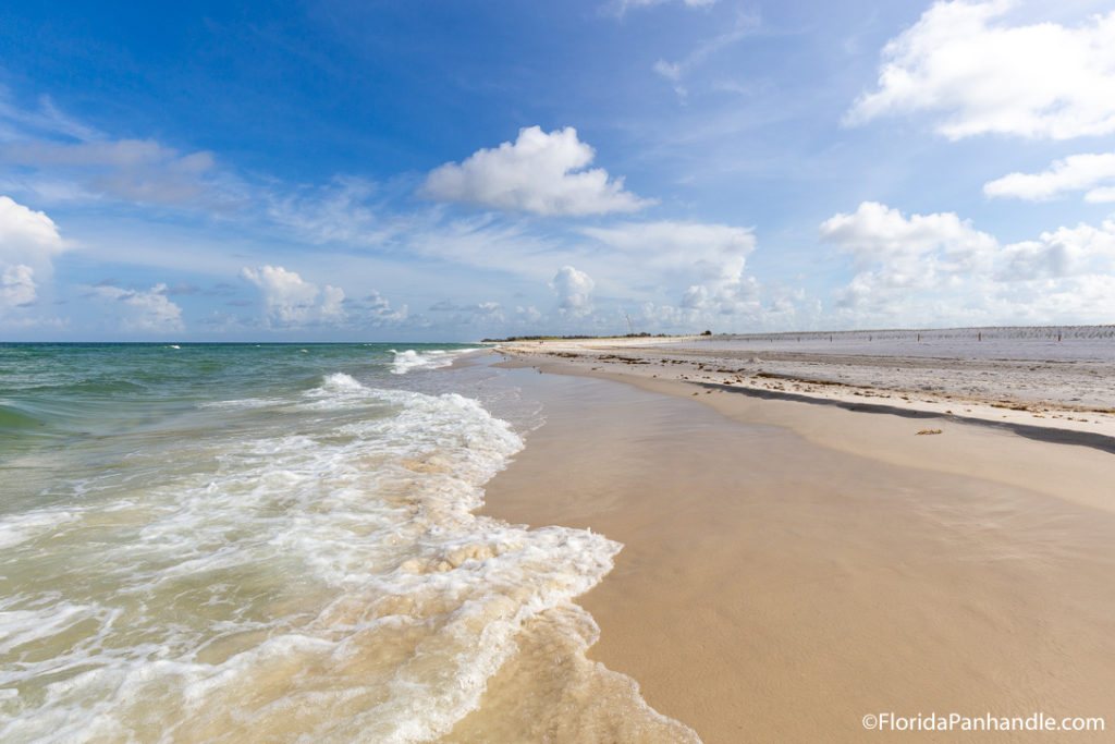beautiful caramel sanded beach as the water rushes onto the shore on a cleared sunny day at St. Joseph Peninsula State Park in Florida 